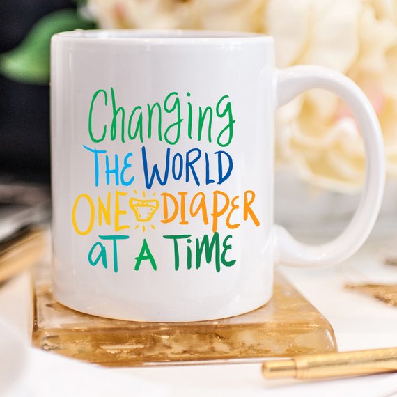 Changing The World One Diaper At A Time Mug by Magenta Shadow Coffee & Tea Cups