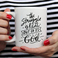 The Struggle Is Real But So Is God Mug by Magenta Shadow Coffee & Tea Cups
