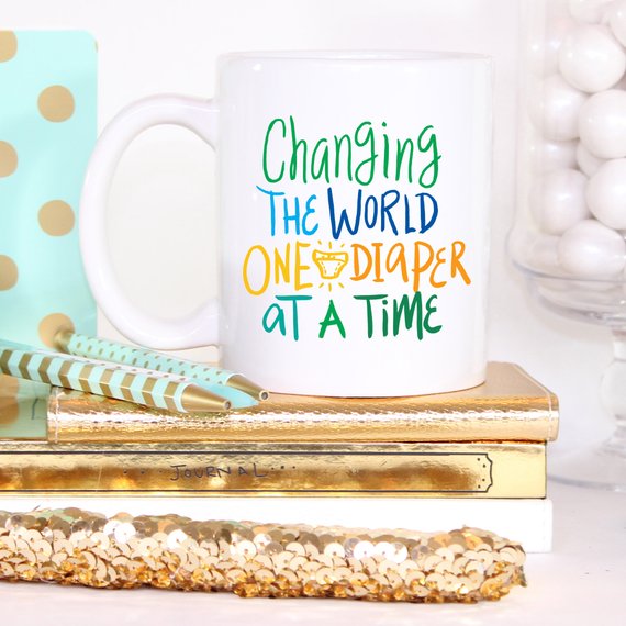 Changing The World One Diaper At A Time Mug by Magenta Shadow Coffee & Tea Cups